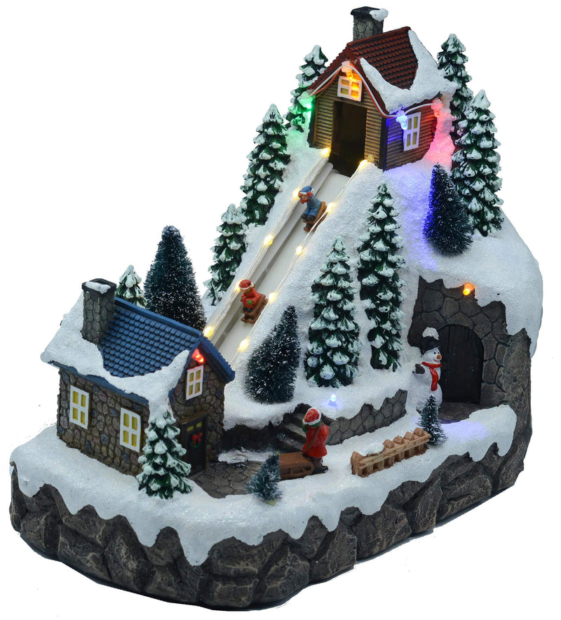 Villaggio Natalizio in Resina Pista da Sci con Luci e Suoni 28x16xh25 cm
